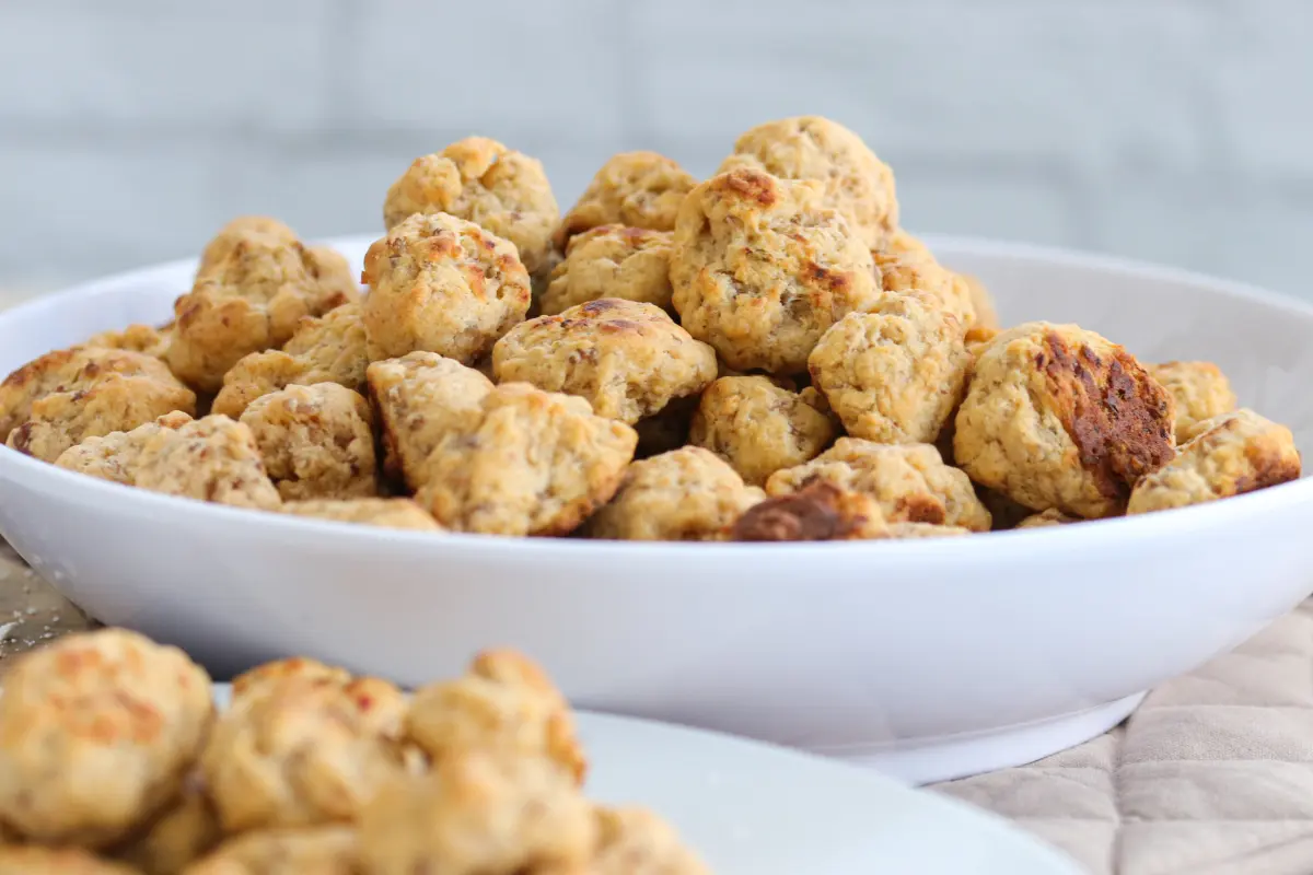 Red Lobster sausage balls with a crispy exterior, served in a white bowl, encapsulating the fusion of traditional sausage and seafood flavors.